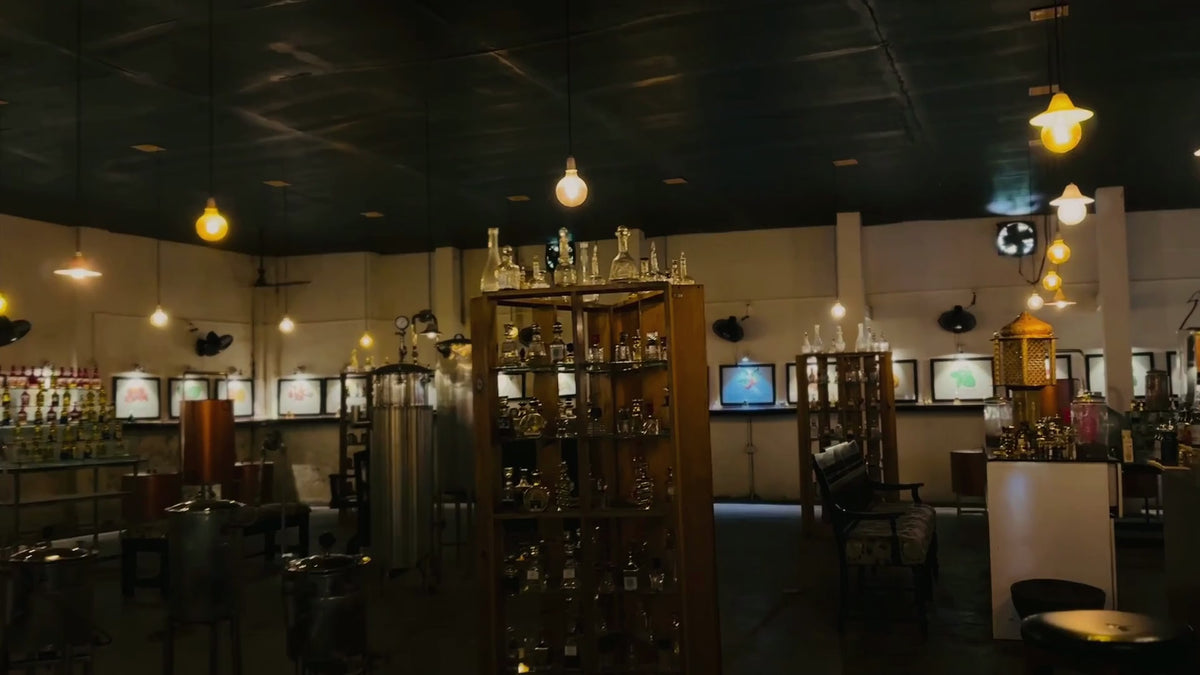 Inside the SPR Perfume Museum in Mattancherry, Jew Town — antique copper stills, glass flasks and warm bulb light